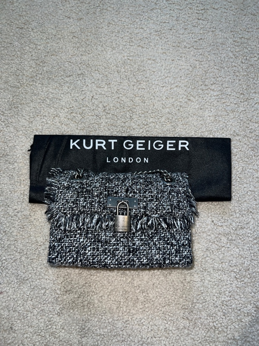 Kurt Geiger T-Mini Brixton Lock Bag in a black and white tweed